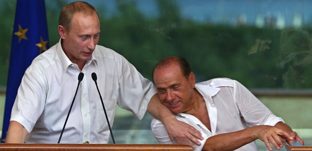 Italian Prime Minister Silvio Berlusconi (L) and Russian President Vladimir Putin (L) joke during their press conference in Sardinia, 29 August 2003. AFP PHOTO STRINGER (Photo credit should read STR/AFP/Getty Images)
