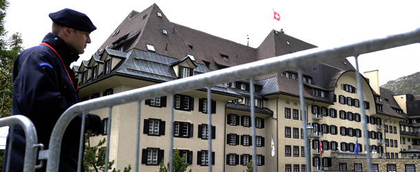 A private policeman guards on June 9, 2011 the Suvretta House five-star hotel in the chic Swiss ski station of St Moritz, where the Bilderberg Group is holding its annual meeting. The secretive Bilderberg Group of some 100 political and economic leaders, as well as aristocrats, is meeting from June 9 to 12 in St Moritz. The group, which has been holding annual off-the record talks open to guests only since 1954, feeds conspiracy theories and speculation about its intentions, with critics accusing it of plotting world domination. AFP PHOTO / FABRICE COFFRINI (Photo credit should read FABRICE COFFRINI/AFP/Getty Images)
