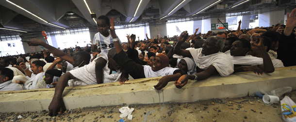 Muslim pilgrims throw pebbles at pillars during the &#8220;Jamarat&#8221; ritual, the stoning of Satan, in Mina near the holy city of Mecca, on November 6, 2011. Pilgrims pelted pillars symbolising the devil with pebbles to show their defiance on the third day of the hajj as Muslims worldwide marked the Eid al-Adha holy day with mass animal sacrifices. AFP PHOTO/FAYEZ NURELDINE (Photo credit should read FAYEZ NURELDINE/AFP/Getty Images)
