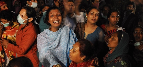 Friends and family members of eunuchs who were injured during a fire at a gathering wail outside the hospital, in New Delhi, India, Sunday, Nov. 20, 2011. A fire tore through a makeshift tent at a gathering of thousands of eunuchs in the Indian capital on Sunday, killing at least 13 people and injuring dozens of others, police said. (AP Photo/Tsering Topgyal)
