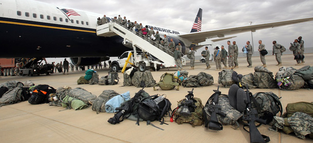 A U.S. army soldiers board a plane as they begin their journey home out of Iraq from the al-Asad Air Base west the capital Baghdad, on November 1, 2011. The massive logistical operation has to be finished by December 31, in line with a security pact between Baghdad and Washington which will see the year-end with drawl of troops from Iraq. Currently there are around 39,000 American soldiers remaining in Iraq, stationed on 15 bases, that compares to peak figures of nearly 170,000 soldiers and 505 bases in 2007 and 2008. AFP PHOTO/ALI AL-SAADI (Photo credit should read ALI AL-SAADI/AFP/Getty Images)
