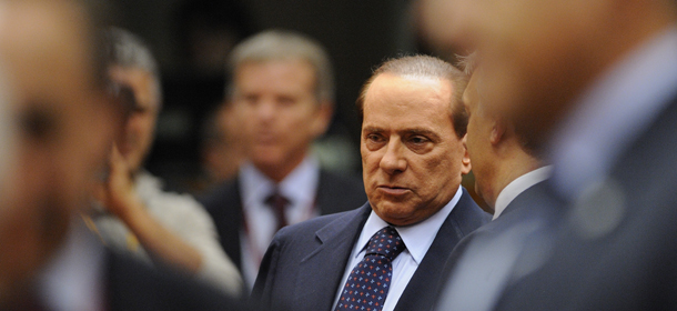 Italian Prime Minister Silvio Berlusconi looks on as he attends a working session of the European Council at the Justus Lipsius building, EU headquarters in Brussels, on October 26, 2011. The European Commission called on eurozone leaders to deliver a &#8220;credible&#8221; response to the debt crisis at a crunch summit today as they are scheduled to announce in Brussels a plan to boost confidence in the eurozone after months of indecision and uncertainty. The EU is trying to prevent a full-blown Greek default and limit contagion within the eurozone after Ireland and Portugal also required bailouts and Italy begins to look vulnerable. AFP PHOTO/ ERIC FEFERBERG (Photo credit should read ERIC FEFERBERG/AFP/Getty Images)
