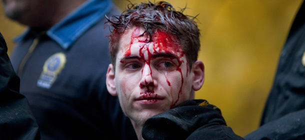 NEW YORK, NY &#8211; NOVEMBER 17: A man who identifed himself as Brendan Watts is seen with blood on his face while surrounded by three police officers in Zuccotti Park on November 17, 2011 in New York City. A fight broke out between protestors affiliated with Occupy Wall Street and police, in which Watts was injured. (Photo by Andrew Burton/Getty Images)

