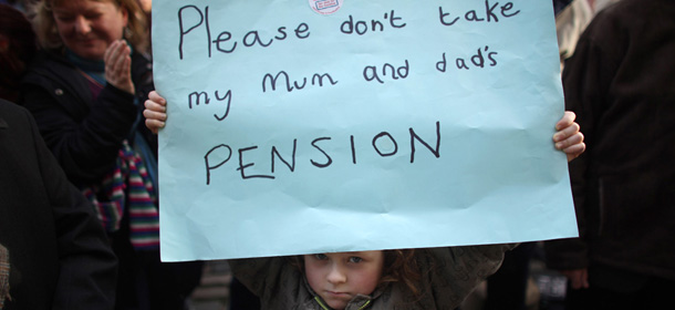 LIVERPOOL, ENGLAND &#8211; NOVEMBER 30: A young girl holds a placard as thousands of strikers take part in a rally outside Liverpool&#8217;s St George&#8217;s Hall on November 30, 2011 in Liverpool, England. More than 2 million public sector workers are staging a nationwide strike over cuts to their public sector pensions. The strike began at midnight leading to the closure of most state schools, disruption to rail and tunnel services, delays at border areas inside airports and ferry terminals and the postponement of thousands of non-emergency hospital operations. The TUC has said it is the biggest stoppage in more than 30 years, with hundreds of marches and rallies due to take place in cities and towns across the UK. (Photo by Christopher Furlong/Getty Images)

