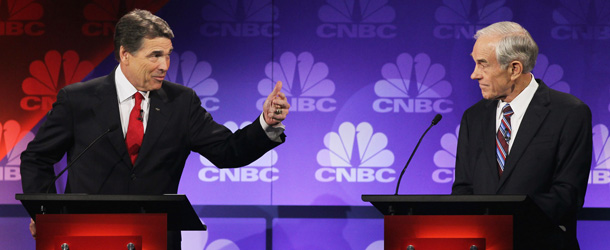 ROCHESTER, MI &#8211; NOVEMBER 09: Texas Gov. Rick Perry (L) speaks as U.S. Rep. Ron Paul (R-TX) looks on during a debate hosted by CNBC and the Michigan Republican Party at Oakland University on November 9, 2011 in Rochester, Michigan. The debate is the first meeting of the eight GOP presidential hopefuls since allegations of sexual impropriety have surfaced against front-runner Herman Cain. (Photo by Scott Olson/Getty Images)
