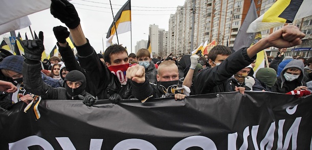 Ultra nationalist demonstrators and activists march carrying the banner reads as &#8220;Russian march&#8221; to mark National Unity Day on the outskirts of Moscow, Russia, Friday, Nov. 4, 2011. Chanting &#8220;Russia for Russians&#8221; and &#8220;Migrants today, occupiers tomorrow,&#8221; about 5,000 people, mostly young men, marched through a working-class neighborhood on the outskirts of the capital, while police stood shoulder to shoulder along the street, which was blocked to traffic.(AP Photo/Alexander Zemlianichenko)
