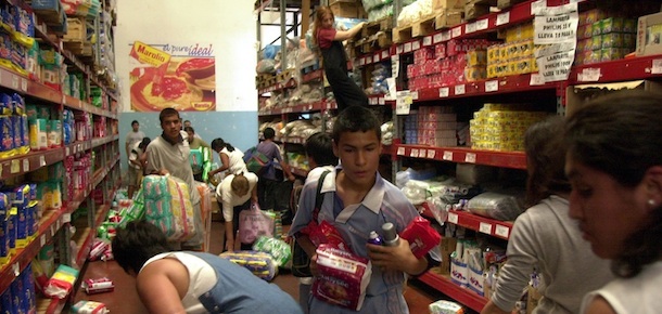 Looters gather merchandise in a supermarket on the outskirts of Buenos Aires, Wednesday, Dec. 19, 2001. Jobless Argentines stormed supermarkets, shops and kiosks on Wednesday as Argentina&#8217;s long-festering economic crisis boiled over on the poor fringes of Buenos Aires.(AP Photo/Daniel Luna)
