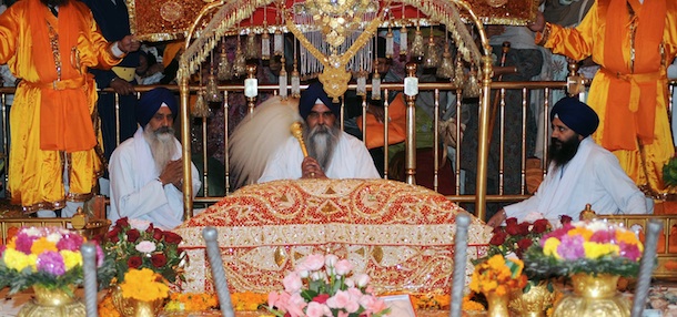 Indian Sikh head Priest Jaswinder Singh (C) sits behind the Sikh Holy Book during a &#8216;Jalau&#8217;, a splendour show of Sikhism&#8217;s symbolic items, inside the Sikh Shrine Golden Temple in Amritsar on November 10, 2011. The &#8216;Jalau&#8217; took place on the occasion of the 542nd birthday of Sri Guru Nanak Dev. Guru Nanak was the founder of the religion of Sikhism and the first of ten Sikh Gurus. AFP PHOTO/NARINDER NANU (Photo credit should read NARINDER NANU/AFP/Getty Images)
