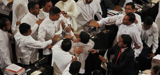 Sri Lanka&#8217;s ruling party lawmakers, top scuffle with opposition law makers, bottom, during a budget speech by President Mahinda Rajapaksa in Colombo, Sri Lanka, Monday, Nov. 21, 2011. Opposition lawmakers walked out after the attack. It was not immediately clear whether anyone was injured.(AP Photo/ Eranga Jayawardena)
