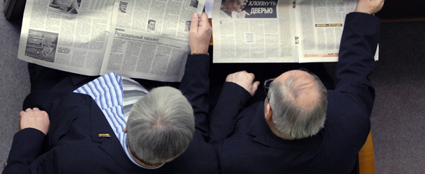 Ukraine&#8217;s deputies read newspapers with Yulia Tymoshenko pictures and with a stories headed with headlines reading &#8220;Yulia Tymoshenko decided to bang the door&#8221; and &#8220;Yulia Tymoshenko warpath&#8221; during the parliament&#8217;s sittings in Kiev on February 10, 2010. Ukraine&#8217;s triumphant presidential election candidate Viktor Yanukovych on Wednesday called on his defeated rival Yulia Tymoshenko to resign as prime minister to avert a new political crisis. AFP PHOTO/ IGOR DOBROVOLSKY (Photo credit should read Igor DOBROVOLSKY/AFP/Getty Images)
