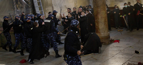Palestinian police officers intervene in a fight that erupted between Greek Orthodox and Armenian clergymen during the cleaning of the Church of the Nativity in the West Bank town of Bethlehem, Wednesday, Dec. 28, 2011. The two denominations each control sections of the church and fiercely guard their turf. The violence broke out when the sides accused each other of crossing into each other&#8217;s territory. Similar fights have taken place in past years. (AP Photo/Bernat Armangue)
