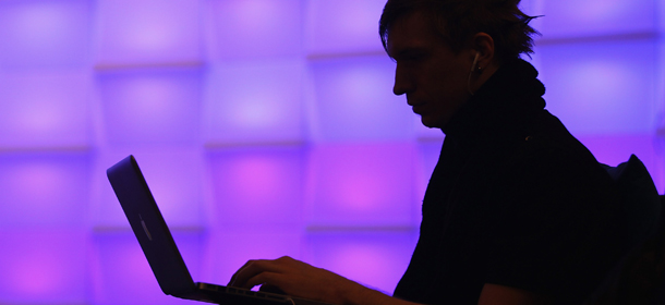 BERLIN, GERMANY &#8211; DECEMBER 28: A participant sits with a laptop computer as he attends the annual Chaos Communication Congress of the Chaos Computer Club at the Berlin Congress Center on December 28, 2010 in Berlin, Germany. The Chaos Computer Club is Europe&#8217;s biggest network of computer hackers and its annual congress draws up to 3,000 participants. (Photo by Sean Gallup/Getty Images)
