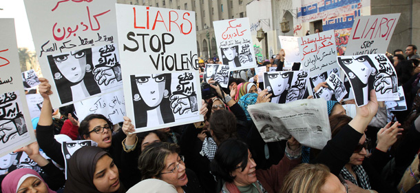 Egyptian women hold signs during a protest in downtown Cairo on December 20, 2011 to denounce the military&#8217;s attacks on women and to call for an immediate end to the violence against protesters. AFP PHOTO/KHALED DESOUKI (Photo credit should read KHALED DESOUKI/AFP/Getty Images)
