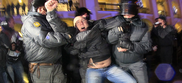 Russian police officers detain an opposition activist during a protest against vote rigging in St. Petersburg, Russia, Sunday, Dec. 4, 2011. Russians cast their ballots with muted enthusiasm in parliamentary elections Sunday, a vote opinion polls suggest could reduce the strength of Prime Minister Vladimir Putin&#8217;s party. Rival parties and election monitors, which have suffered from government crackdowns, alleged significant violations at the polls. (AP Photo/Dmitry Lovetsky)
