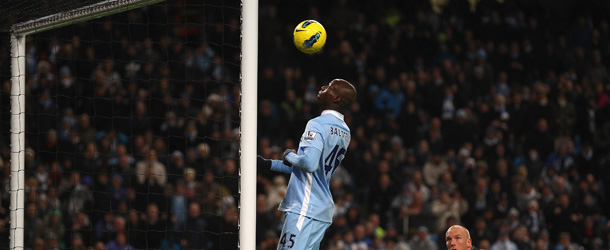 MANCHESTER, ENGLAND &#8211; DECEMBER 03: Mario Balotelli of Manchester City about to score the fourth goal as Norwich City keeper John Ruddy watches during the Barclays Premier League match between Manchester City and Norwich City at Etihad Stadium on December 3, 2011 in Manchester, England. (Photo by Clive Brunskill/Getty Images)
