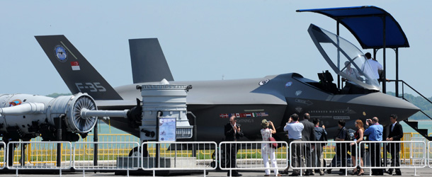 Visitors take a closer look at the static display of Lockheed Martin F-35 fighter jet at the Singapore Airshow 2010 in Singapore on February 2, 2010. The United States has urged China not to slap sanctions on US companies selling arms to Taiwan, as the firms tried to stay out of President Barack Obama&#8217;s biggest row yet with Beijing. AFP PHOTO/ROSLAN RAHMAN (Photo credit should read ROSLAN RAHMAN/AFP/Getty Images)
