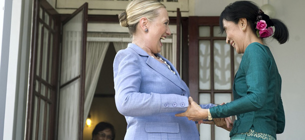 Pro-democracy opposition leader Aung San Suu Kyi (R) and US Secretary of State Hillary Clinton smile as they speak after meeting at Suu Kyi&#8217;s residence in Yangon, Myanmar, December 2, 2011. Clinton is traveling to the country on a two-day visit, the first by a US Secretary of State in more than 50 years. AFP PHOTO / POOL / Saul LOEB (Photo credit should read SAUL LOEB/AFP/Getty Images)
