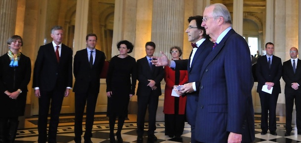 Belgian Prime Minister Elio Di Rupo (L) walks after taking an oath beside King Albert II (R) on December 6, 2011 at the the royal castle of Laeken in Brussels. Belgium finally swore in a government Tuesday ending a record 541-day crisis, but the new Socialist-led coalition will face an uphill struggle to tackle problems at the root of the deadlock. After 18 months without a government, King Albert II swore in Prime Minister Elio Di Rupo, sporting one of his iconic red bow-ties, and then his 12 cabinet ministers and six secretaries of state, one by one. AFP PHOTO GEORGES GOBET (Photo credit should read GEORGES GOBET/AFP/Getty Images)
