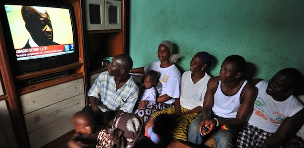 Member of the Dosso family, whose mother, grand mother and five brothers have been reportedly killed by pro-Gbagbo militiamen on April 12, 2011 in the Youpogon popular district of Abidjan, watch on television the former president&#8217;s initial appearance at the International Criminal Court (ICC) in the Hague on December 5, 2011 in Abidjan. Ex-Ivorian president Laurent Gbagbo on Monday blamed the French military for his arrest in Abidjan earlier this year, as he faced world war crimes judges for the first time. Gbagbo, the first ex-president to be brought before the Hague-based International Criminal Court, is facing four counts of crimes against humanity, including murder, and rape, over post presidential poll violence the UN said left some 3,000 people dead. AFP PHOTO / ISSOUF PHOTO (Photo credit should read ISSOUF SANOGO/AFP/Getty Images)
