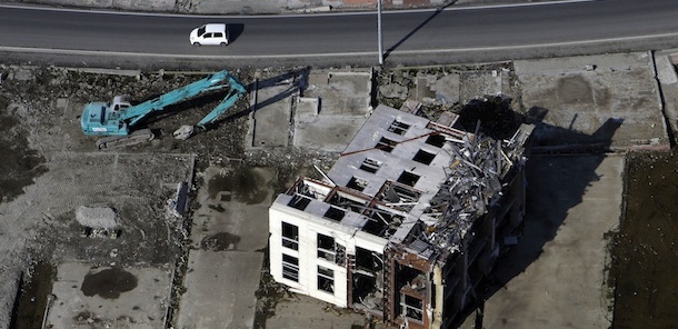 A three-story building lies on its side at Onagawa, in northeast Japan, Friday, Nov. 18, 2011. Though much of the debris left by the March 11 tsunami has been removed, eight months later there is little sign of rebuilding in communities across northeast Japan. (AP Photo/Greg Baker)
