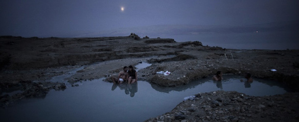 Israelis bathe in the hot springs on the shore of the Israeli Dead Sea near Kibbutz Ein Gedi on November 10, 2011. The Dead Sea is one of the sites candidate of other 28 sits in a international online campaign votes to select the new Seven Wonders of World Heritage Sites. AFP PHOTO / MENAHEM KAHANA (Photo credit should read MENAHEM KAHANA/AFP/Getty Images)
