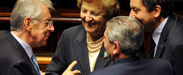 Italy&#8217;s Prime minister Mario Monti (L) smiles with ministers at the end of a confidence vote at the Senate on December 22, 2011 in Rome. Italian senators gave their approval on Thursday to austerity tax increases and pension reforms in a bid to avoid bankruptcy for the eurozone&#8217;s third-biggest economy as a recession looms. Monti&#8217;s government had called a confidence vote on the package in the Senate to ensure that the unpopular measures went through before Christmas to shore up sagging confidence in Italy on the financial markets. AFP PHOTO/ANDREAS SOLARO (Photo credit should read ANDREAS SOLARO/AFP/Getty Images)
