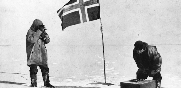 Norwegian explorer Captain Roald Amundsen taking sights at the South Pole, beside the Norwegian flag. (Photo by Illustrated London News/Getty Images)
