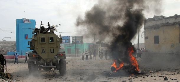 African Union Mission in Somalia (AMISOM) troops ride an amoured vehicle past a burning car after it exploded in Somalia&#8217;s capital, Mogadishu, Tuesday, Dec. 6, 2011. The explosives-laden car went off at an area called Kilometer 4. Several people were killed and injured accoding to an eye witness and an emergency official. Somalia&#8217;s capital has seen a wave of blasts since Islamists withdrew from the city in August(AP Photo/Farah Abdi Warsameh)
