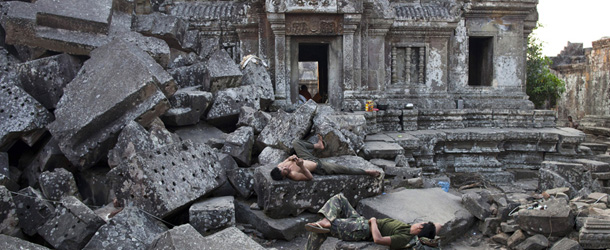 PREAH VIHEAR, CAMBODIA &#8211; FEBRUARY 9: Cambodian soldiers rest on the ruins of the ancient Preah Vihear temple where a military camp has been set up February 9, 2011 in Preah Vihear province, Cambodia. Thousands of refugees were moved 80 km away from the Preah Vihear temple as tensions remain high on both sides of the border. The 11th century Hindu temple, a UNESCO World Heritage Site, has been the subject of a lengthy dispute between the two countries over ownership of the 4.6-sq-km contested area. Currently there is there is an uneasy pause to the fighting, but no official ceasefire in place. (Photo by Paula Bronstein/Getty Images)
