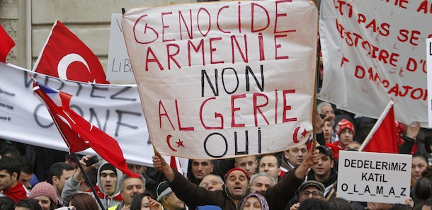 Demonstrators of France&#8217;s Turkish community protest outside the parliament in Paris, Thursday, Dec. 22, 2011. Lawmakers are to vote on a measure that would make it a crime in France to deny that the mass killings of Armenians in 1915 amounted to a genocide, a measure that could put France on a collision course with Turkey, a strategic ally. Turkey wants the killings left to historians and has lashed out at France, warning that it will withdraw its ambassador if the measure becomes law. Banner reads &#8221; Armenian Genocide No, Algeria Yes &#8221; referring to the French colonial war in Algeria. (AP Photo/Michel Euler)

