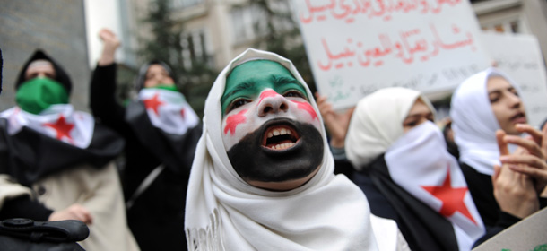 A young woman with her face painted with the Syrian flag attends a demonsration against Syrian President Bashar al-Assad in front of Syrian Consulate, following the Friday prayer on December 16, 2011 in Istanbul. More than 5000 people have been killed in Syria since pro-democracy protests began mid March, according to the United Nations. AFP PHOTO / BULENT KILIC (Photo credit should read BULENT KILIC/AFP/Getty Images)