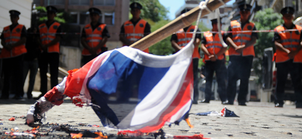 Argentine activists burn a Union Jack during a demonstration in front of the British embassy in Buenos Aires on January 20, 2012, against the recent statements by British Prime Minister David Cameron accusing Buenos Aires of "colonialism" in reference to the disputed Falkland (Malvinas) Islands. AFP PHOTO/SERGIO GOYA (Photo credit should read SERGIO GOYA/AFP/Getty Images)