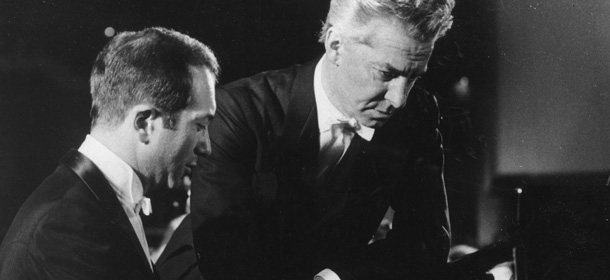 FILE This is a 1976 file photo of pianist Alexis Weissenberg. left, and Austrian conductor Herbert von Karajan , as they go over a part at the grand piano in West Berlin. Bulgarian-born pianist Alexis Weissenberg, whose love of music from the age of 3 saved him and his mother in a concentration camp and carried him to the heights of 20th century performances with Herbert von Karajan and Leonard Bernstein, has died. He was 82. Bulgaria's Ministry of Culture confirmed Monday Jan. 9, 2012 the death of Weissenberg, who was born in the capital Sofia but spent most of his life abroad and became a French citizen. (AP Photo, File)