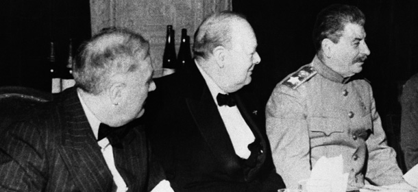 American President Franklin D. Roosevelt, left, British Prime Minister Winston Churchill, centre, and Russian Premier Joseph Stalin sit together at the dinner table in Teheran, Iran on Dec. 10, 1943, during their conference in the City. (AP Photo)