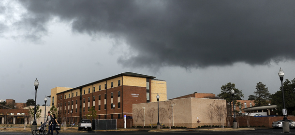 A couple walk across the parking lot with their baby outside the Lumberjack Landing dormitory at Stephen F. Austin State University Wednesday, Jan. 25, 2012, in Nacogdoches, Texas. Rainstorms and strong winds across parts of Texas have left thousands of people without electricity and facing the threat of worse conditions. (AP Photo/The Daily Sentinel, Andrew D. Brosig) MANDATORY CREDIT