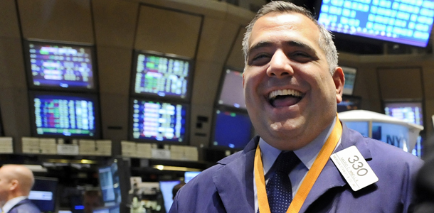 Trader Robert Innella smiles as he works on the floor of the New york Stock Exchange, Wednesday, Nov. 26, 2008. A stock market gaining confidence in the nation's financial system bolted higher Wednesday, propelling the Dow Jones industrials and Standard &amp; Poor's 500 index to their first four-day advance since last spring. (AP Photo/Richard Drew)