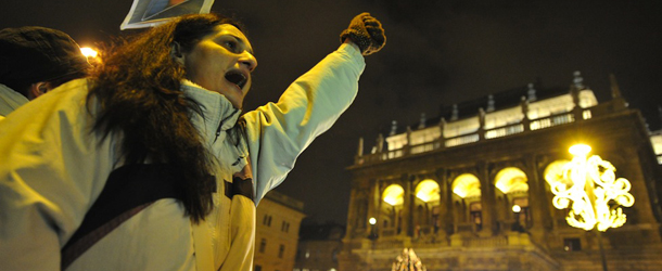 A local citizen shouts an anti-government slogan in front of the building of the Hungarian National Opera on January 2, 2012. Tens of thousands protested against Hungary's new constitution which critics said curbed democracy, while the governing centre-right government celebrated the new law at a gala event. They protested against the government of Viktor Orban and the controversial new constitution that entered into force on January 1, renaming "the Republic of Hungary" to "Hungary. AFP PHOTO / ATTILA KISBENEDEK (Photo credit should read ATTILA KISBENEDEK/AFP/Getty Images)