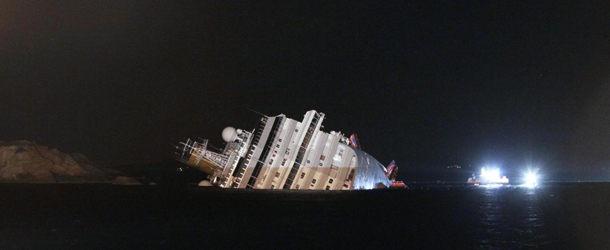 The luxury cruise ship Costa Concordia leans on its side after running aground the tiny Tuscan island of Giglio, Italy, Saturday, Jan. 14, 2012. The ship ran aground off the coast of Tuscany, sending water pouring in through a 160-foot (50-meter) gash in the hull and forcing the evacuation of some 4,200 people from the listing vessel early Saturday, the Italian coast guard said. (AP Photo/Gregorio Borgia)