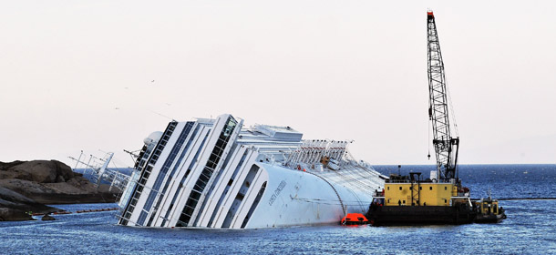 GIGLIO PORTO, ITALY - JANUARY 24: Rotterdam based SMIT and Livorno based NERI salvage workers start their work of diesel recovery on a pontoon from the the cruise ship Costa Concordia that lies stricken off the shore of the island of Giglio on January 24, 2012 in Giglio Porto, Italy. More than four thousand people were on board when the ship hit a rock off the Tuscan coast. The official death toll is now 16, with a further 24 people still missing. The diesel recovery operation will start tomorrow, while the rescue operation will continue. (Photo by Laura Lezza/Getty Images)