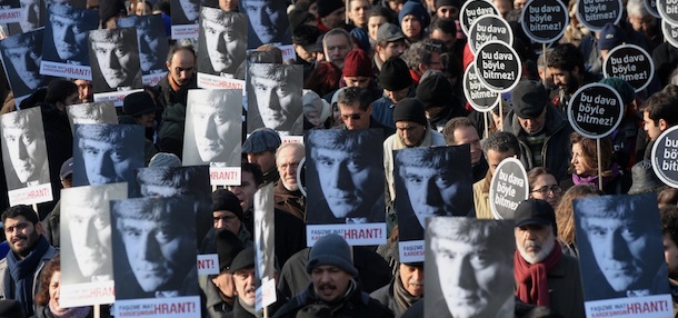 Hundreds of people hold placards that read 'This case won't end this way' and showing a portrait of Hrant Dink, outside a courthouse in Istanbul, Turkey, Tuesday, Jan. 17, 2012. A prosecutor is demanding life imprisonment for seven men accused of involvement in the killing of an ethnic Armenian journalist, Hrant Dink. Dink was shot outside his office in 2007 in an alleged nationalist killing. In July, a juvenile court sentenced a now 21-year-old hardliner to nearly 23 years in prison for killing Dink.(AP Photo)