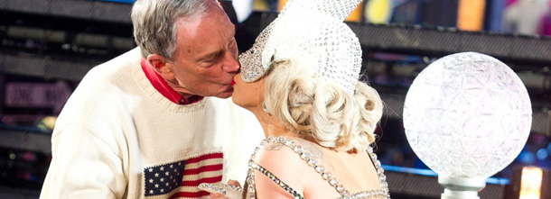 Lady Gaga and New York Mayor Michael Bloomberg, left, kiss during the New Year's celebration, Sunday, Jan. 1, 2012, in New York. (AP Photo/Charles Sykes)