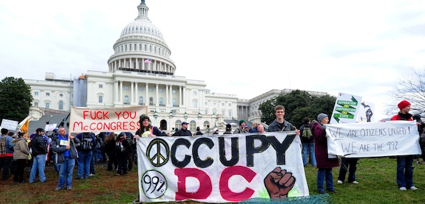 Occupy DC protesters holds a signs January 17, 2012 during a demonstration in front of the Capitol in Washington, DC. Hundreds of Occupiers gathered on the West front lawn of the Capitol for an "Occupy Congress" rally. AFP PHOTO/Karen BLEIER (Photo credit should read KAREN BLEIER/AFP/Getty Images)