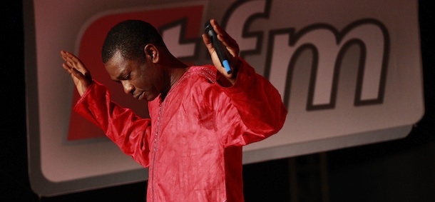 In this Wednesday, Sept. 1, 2010 photo, Senegalese pop star Youssou Ndour performs at the launch of his television station, TFM, in Dakar, Senegal. Outside of Senegal, the 50-year-old chart-topping artist is best-known for his grooving mbalax beat. In his native country, he is also known for his scathing critique of the ruling party. Senegal's government has forbidden Ndour from doing newscasts on his new channel, and the license allowing him to do 'cultural programming' was only granted after a two-year stalemate. (AP Photo/Rebecca Blackwell)