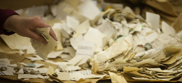 A worker in the former headquarters of the Stasi (East German communist secret police) sorts through hundreds of thousands of torn or shredded Stasi documents earmarked for destruction after the fall of the Berlin wall in 1989, in Berlin January 12, 2012. Workers are sifting through 15.500 bags, containing between 50.000 and 80.000 fragments each. The sorted fragments will then be scanned and virtually reconstructed by a specially designed computer programme. AFP PHOTO JOHN MACDOUGALL (Photo credit should read JOHN MACDOUGALL/AFP/Getty Images)