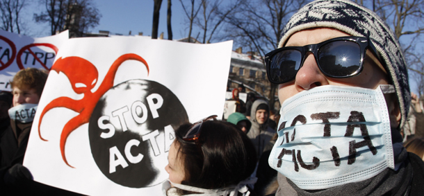 Activists protest against the Anti-Counterfeiting Trade Agreement, or ACTA, in front of the Government palace in Vilnius , Lithuania, Saturday, Feb. 11, 2012. ACTA aims to harmonize international standards on protecting the rights of those who produce music, movies, pharmaceuticals, fashion, and a range of other products that often fall victim to piracy and intellectual property theft, however some Internet users are worried it could lead to online censorship. (AP Photo/Mindaugas Kulbis)