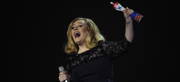 British singer-songwriter Adele celebrates with the British Album of the Year award for her album "21" at the BRIT Awards 2012 in London on February 21, 2012. AFP PHOTO / LEON NEAL (Photo credit should read LEON NEAL/AFP/Getty Images)