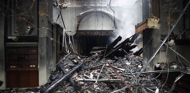 Picture taken on February 13, 2012 shows a burn-out building in central Athens. Global markets climb after Greek lawmakers approve radical budget cuts vital to secure a 130 billion euro rescue package aimed at averting bankruptcy, after a day of street battles left dozens injured and Athens buildings ablaze. According to official figures, 45 buildings were wholly or partly destroyed by fire as violence erupted during demonstrations while parliament voted through the tough new austerity measures aimed at averting national bankruptcy. AFP PHOTO / Angelos Tzortzinis (Photo credit should read ANGELOS TZORTZINIS/AFP/Getty Images)