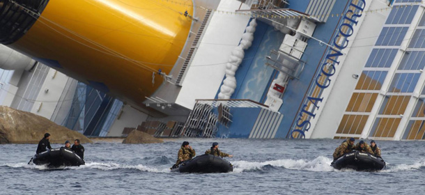 FILE - This is a Monday, Jan. 23, 2012. file photo of Italian Navy scuba divers as they return after working on the grounded cruise ship Costa Concordia off the Tuscan island of Giglio, Italy. Divers searching the capsized Costa Concordia cruise ship found four more bodies Wednesday Feb. 22, 2012, including that of a missing 5-year-old Italian girl, authorities said. (AP Photo/Pier Paolo Cito, File)