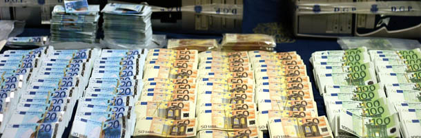 MADRID, SPAIN: This photo taken 23 March 2005 shows the counterfeit Euro bills and equipment seized by Spanish police during a special operation in Madrid. Spanish police have seized 2.5 million counterfeit euros and arrested 27 people, in the largest haul of fake currency since the introduction of the Euro, officials said. AFP PHOTO / Pedro ARMESTRE (Photo credit should read PEDRO ARMESTRE/AFP/Getty Images)