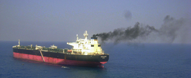 In this photo released by the Indian Navy, Italian cargo ship "Enrica Lexie," left, anchors in the Arabian Sea off Kochi, India, Thursday, Feb. 16, 2012. The Italian cargo ship fired at an Indian fishing boat that it mistook for a pirate vessel, killing two fishermen, India's navy said Thursday. Indian Coast Guard Ship Lakshmibhai is seen on right. (AP Photo/Indian Navy)